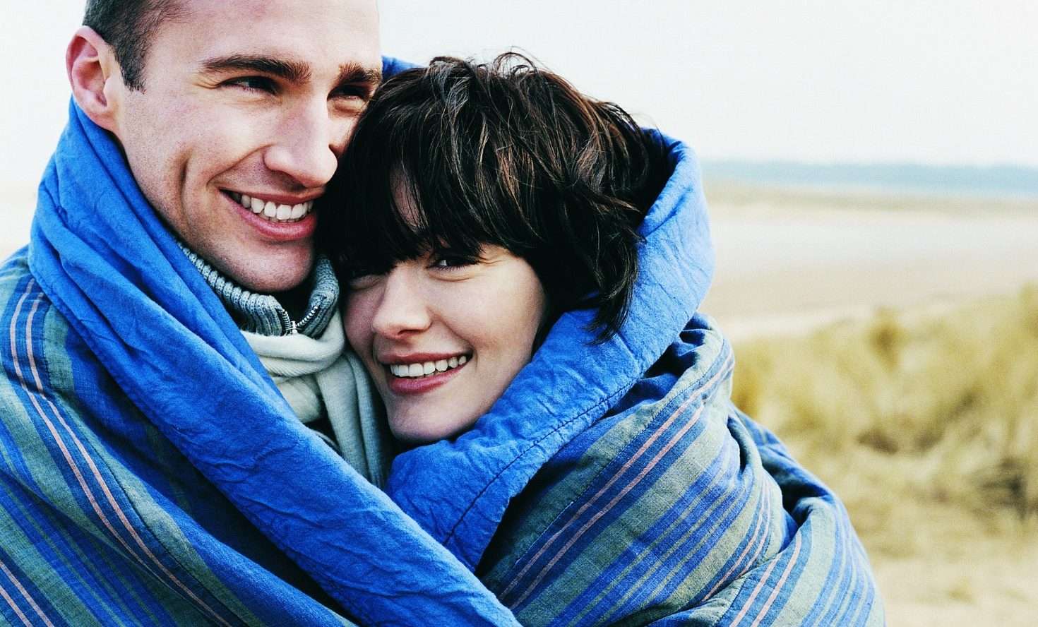 couple cuddling in a blanket at Arcadia Beach State Recreation Site