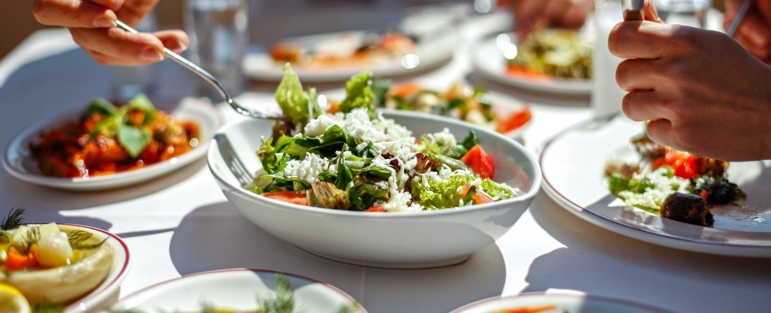 3 Vegan Restaurants In Cannon Beach You Need To Know About Now Hand Reaching Out For Fresh Salad And Vegetable Sides At One Of The Vegan Restaurants In