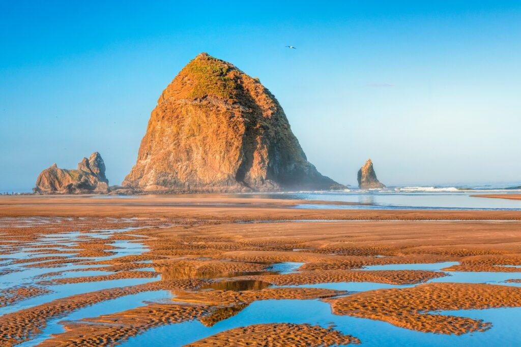 Cannon Beach reflections at low tide, Haystack rock is one of the must-visit Oregon Coast attractions on your next trip